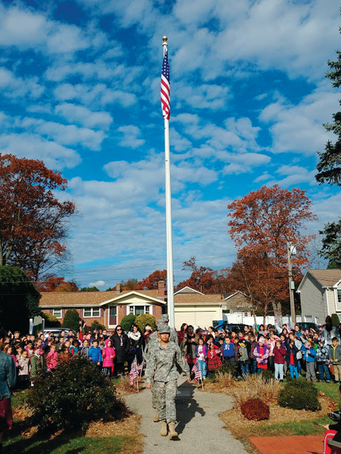 A JOB WELL DONE: The Cranston East JROTC students march out of the ceremony after having raised the new flag at Glen Hills Elementary School in honor of Veterans Day.